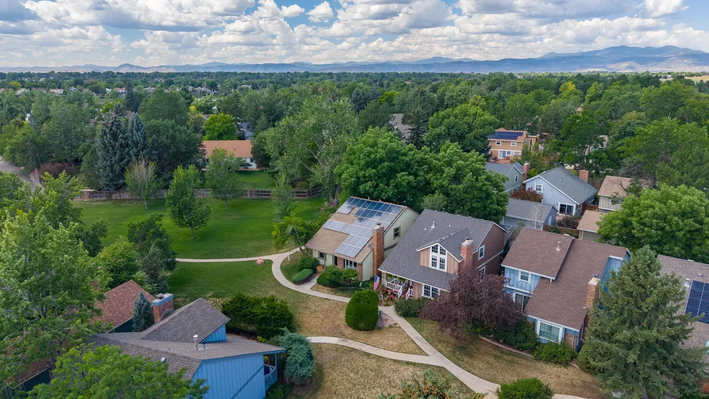 Aerial view of the end-of-row home and its solar array beside the greenbelt path in The Pond, Arvada