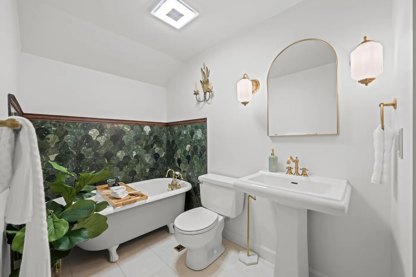 Updated upstairs hall bath with clawfoot tub, handheld shower, and skylight