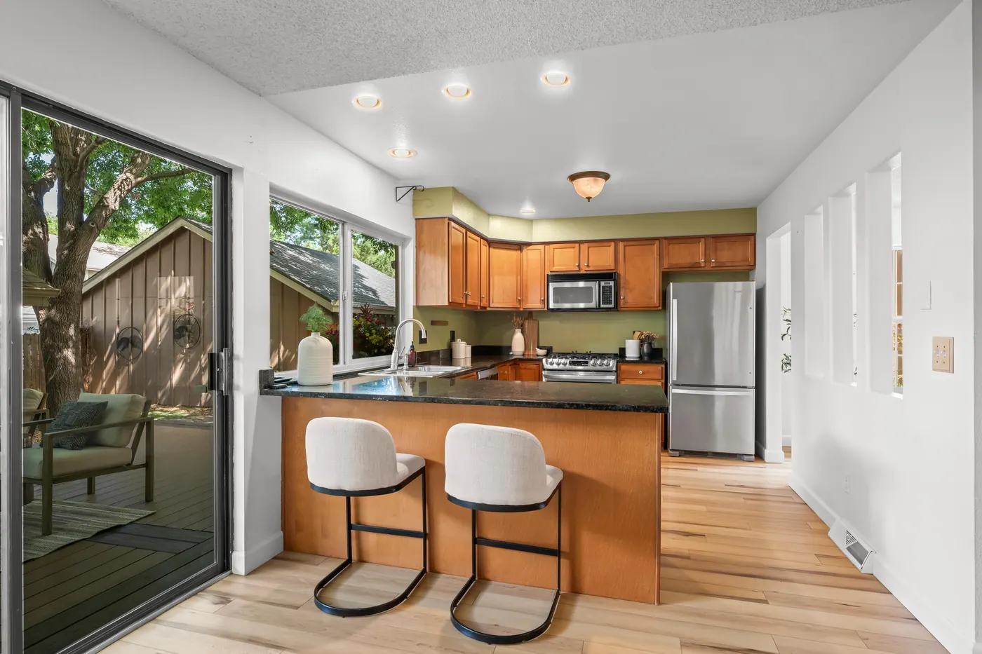 Kitchen breakfast bar and sliding door out to the backyard deck