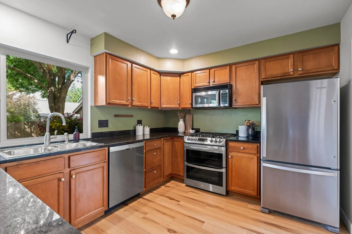 Updated kitchen with granite countertops and stainless steel appliances at 8722 Independence Way, Arvada