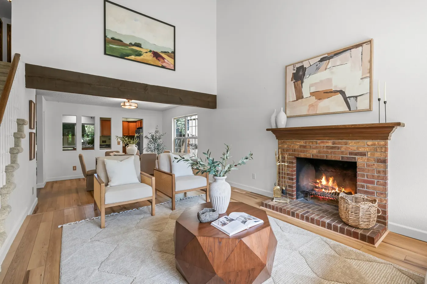 Brick wood-burning fireplace and wood mantel in the living room