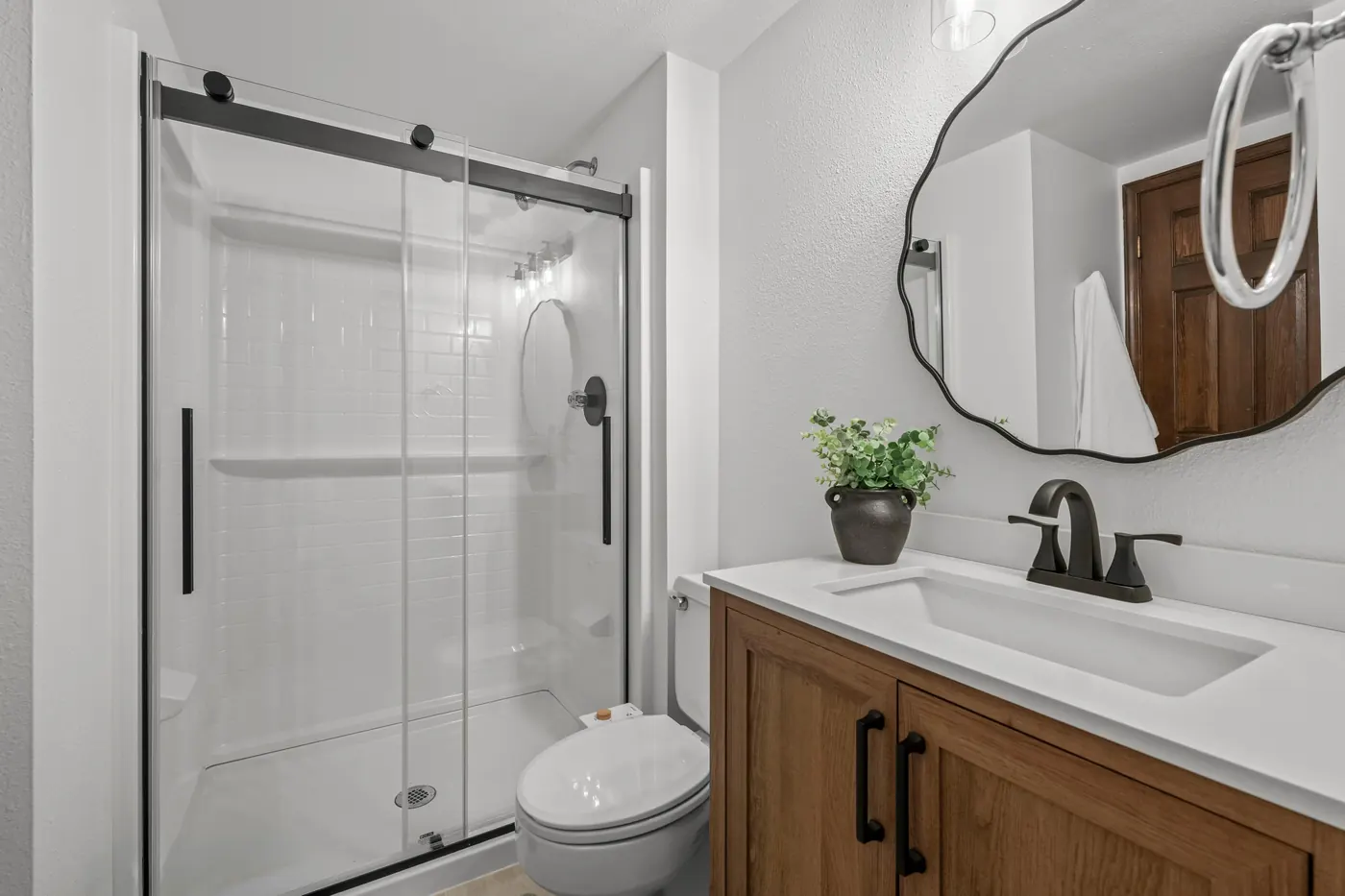 Remodeled main-floor 3/4 bath with glass walk-in shower