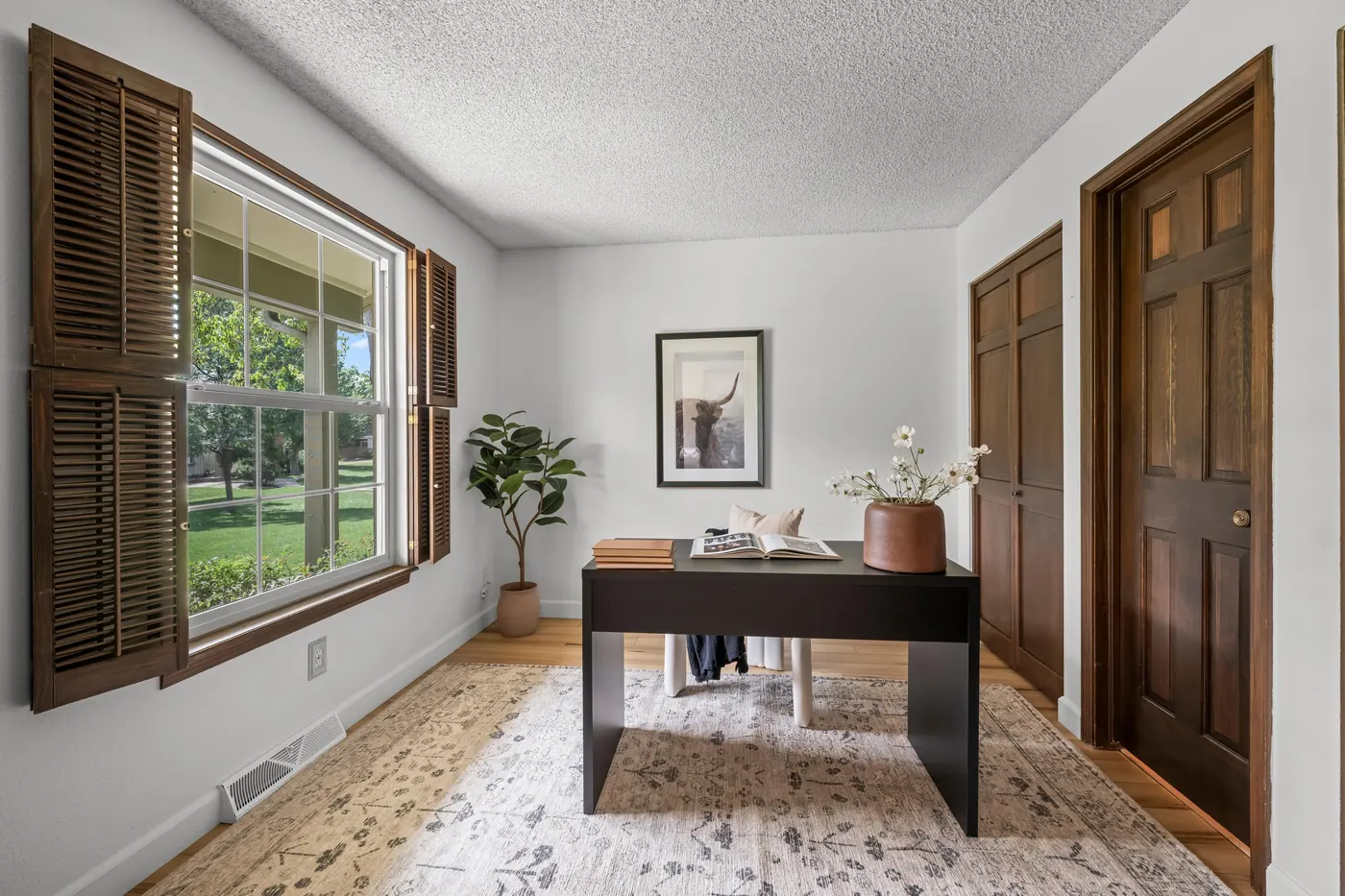 Main-floor 4th bedroom with two closets, staged as an office
