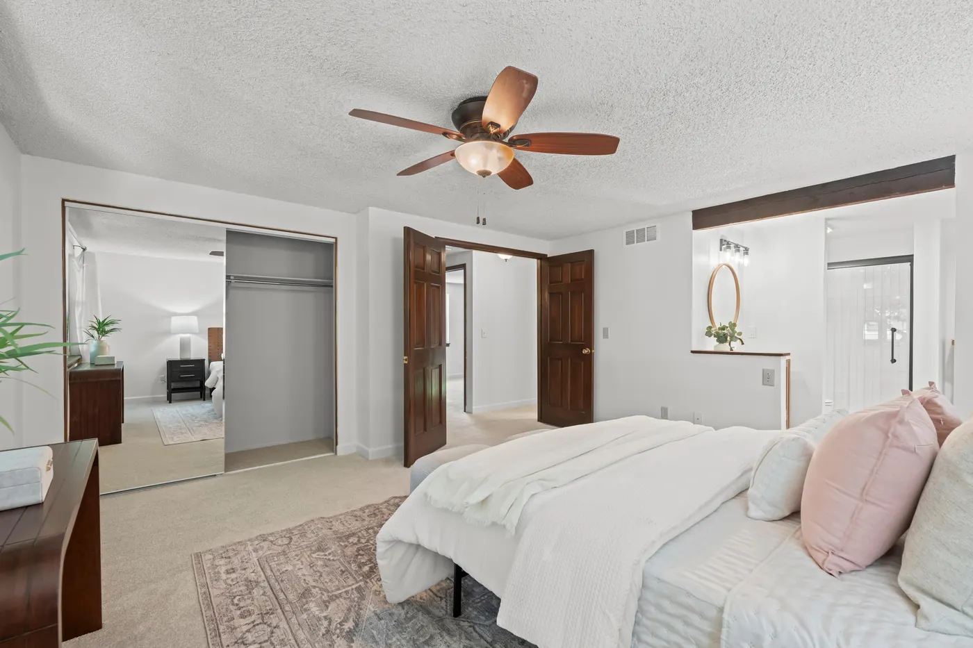Primary suite showing its two closets and the door to the remodeled ensuite bath