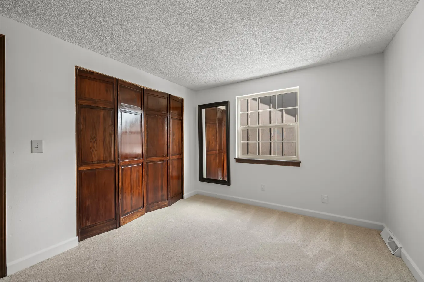 Third upstairs bedroom with wood closet wall and new carpet